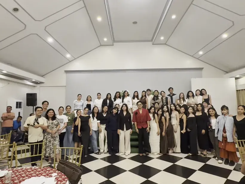 A large group in formal wear at a gala night venue